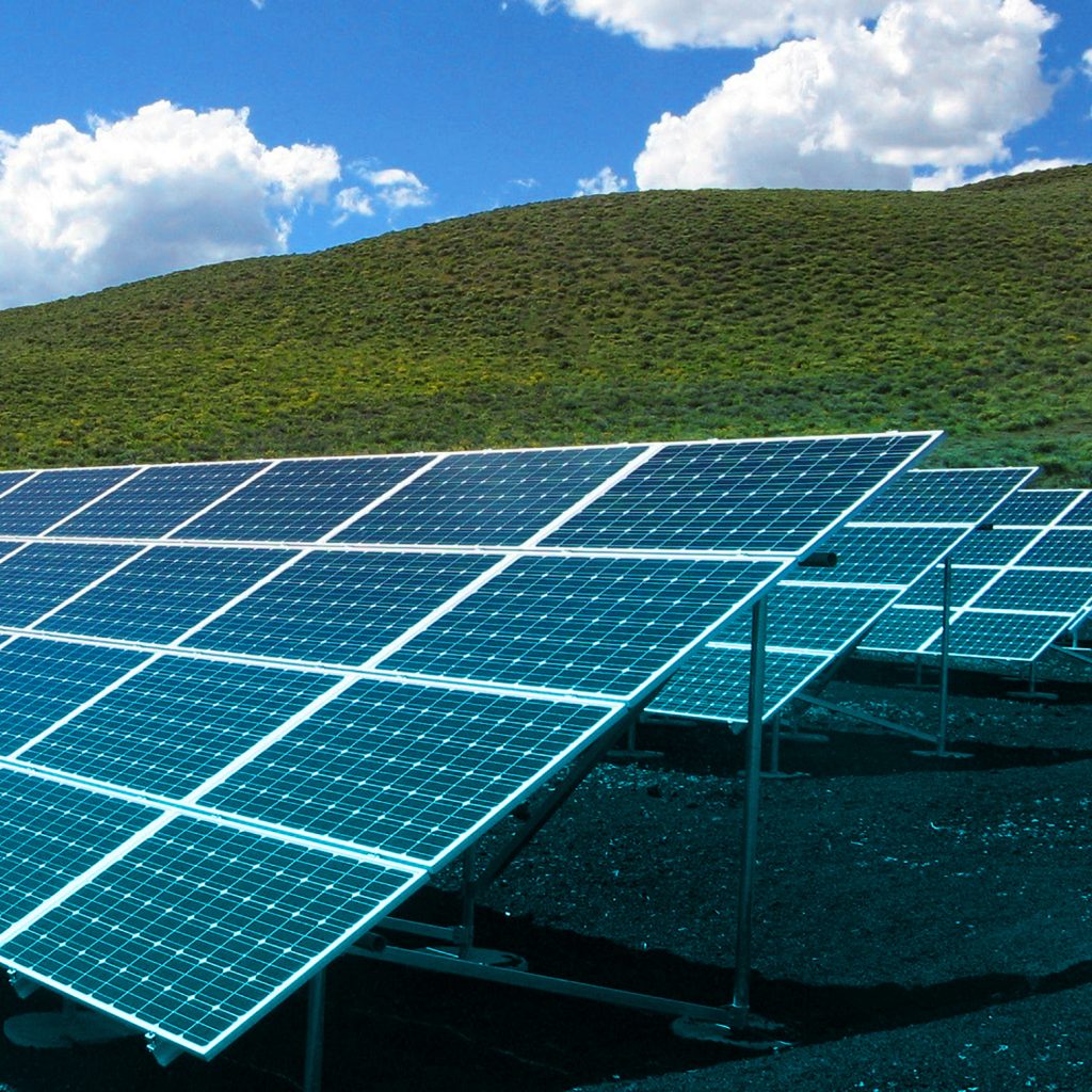 Solar panels on a grassy hill