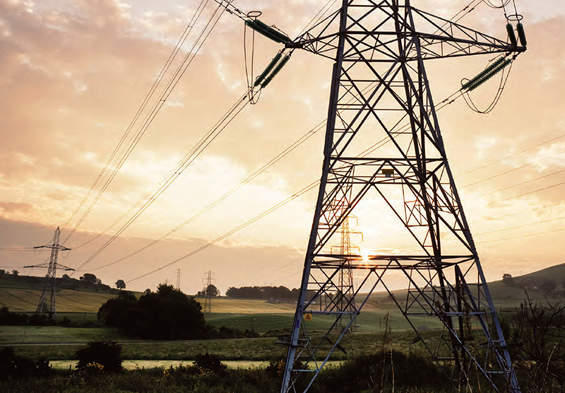 Hydro wires with a sunrise behind it.